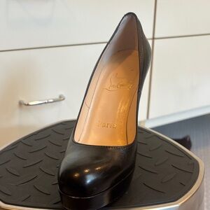Black Louboutin pumps